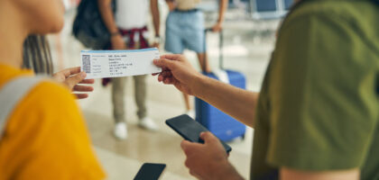 Man asking female about his boarding ticket